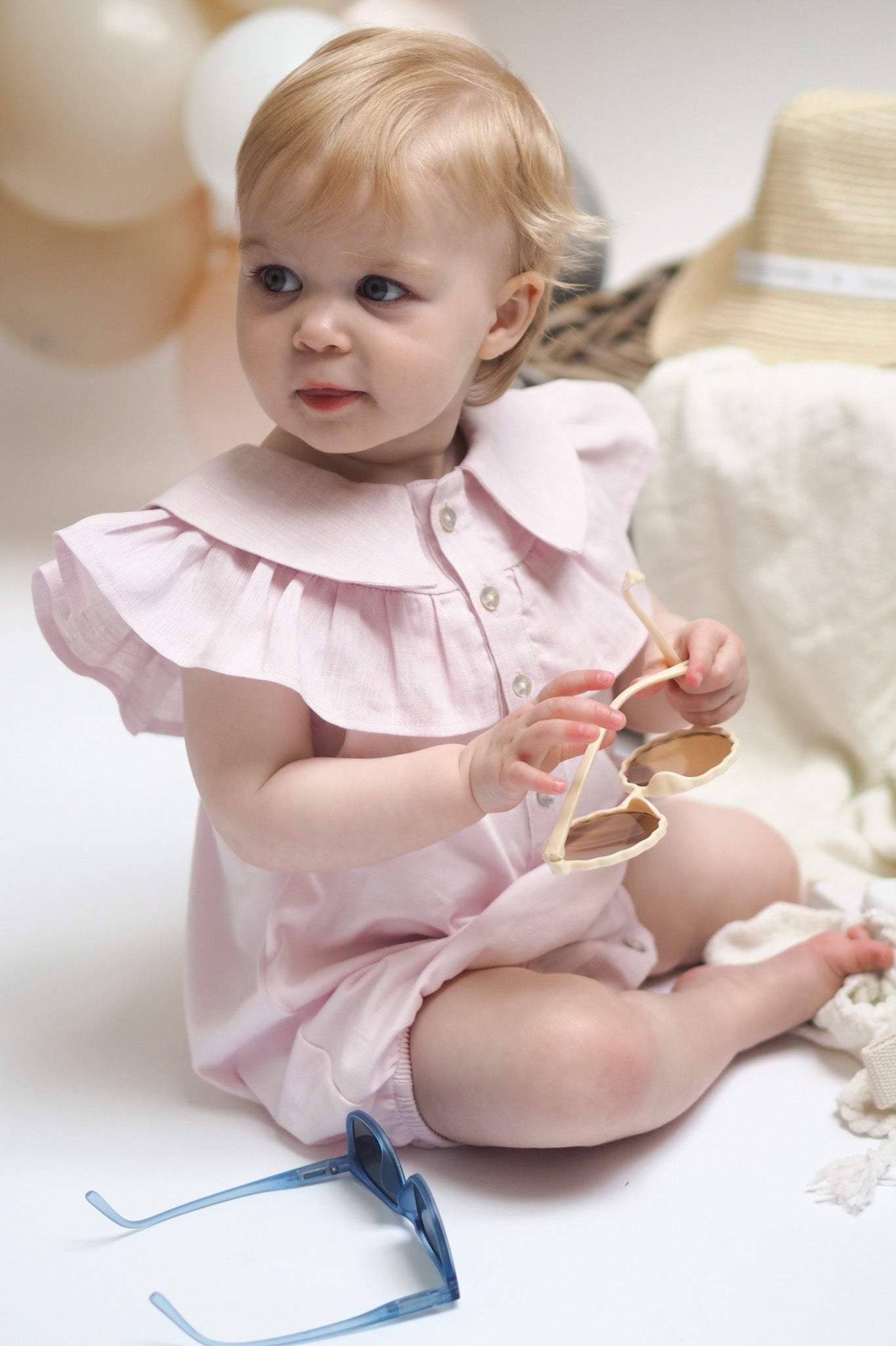 baby girl in pink frill romper