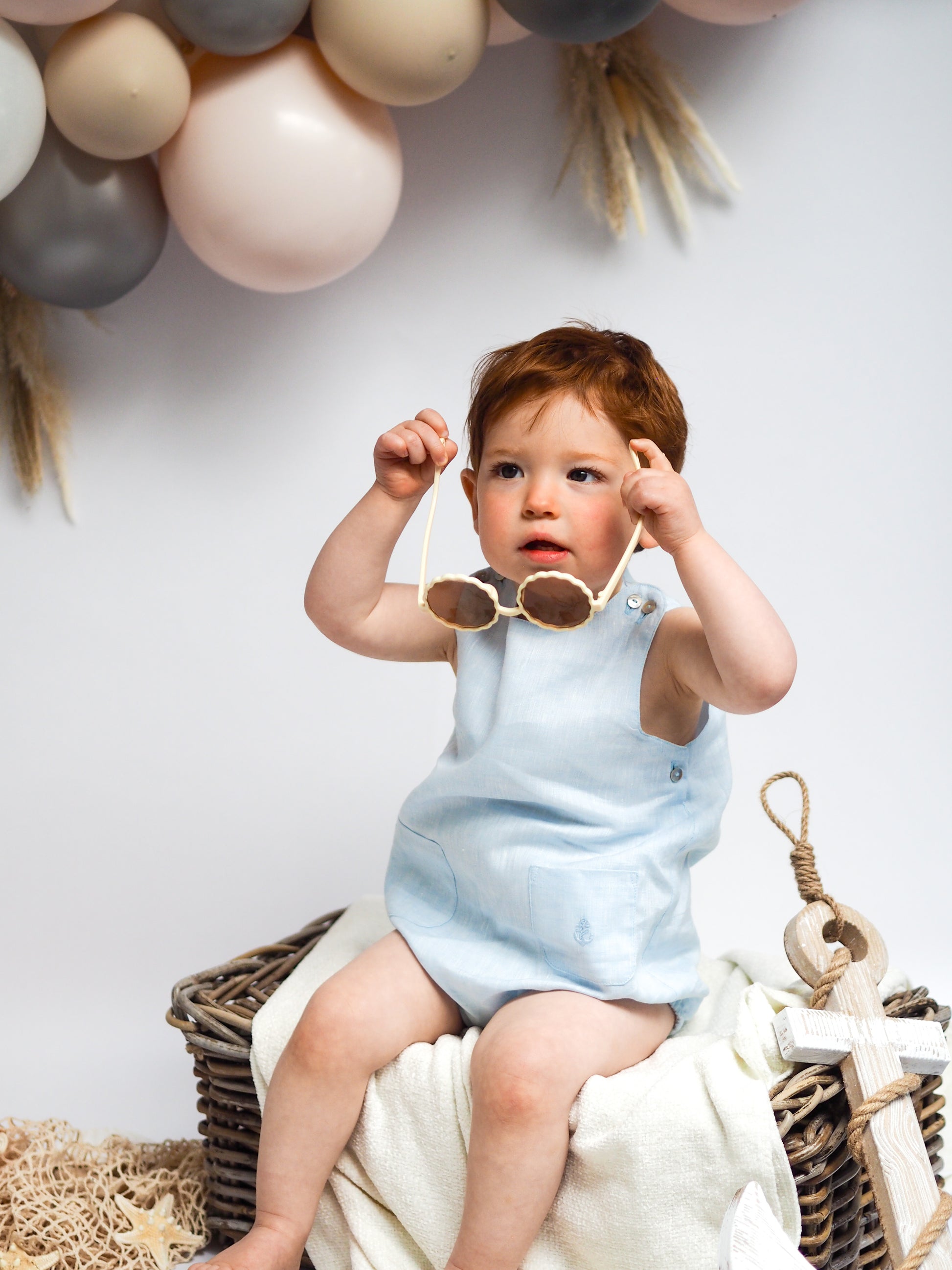 baby boy in blue linen romper